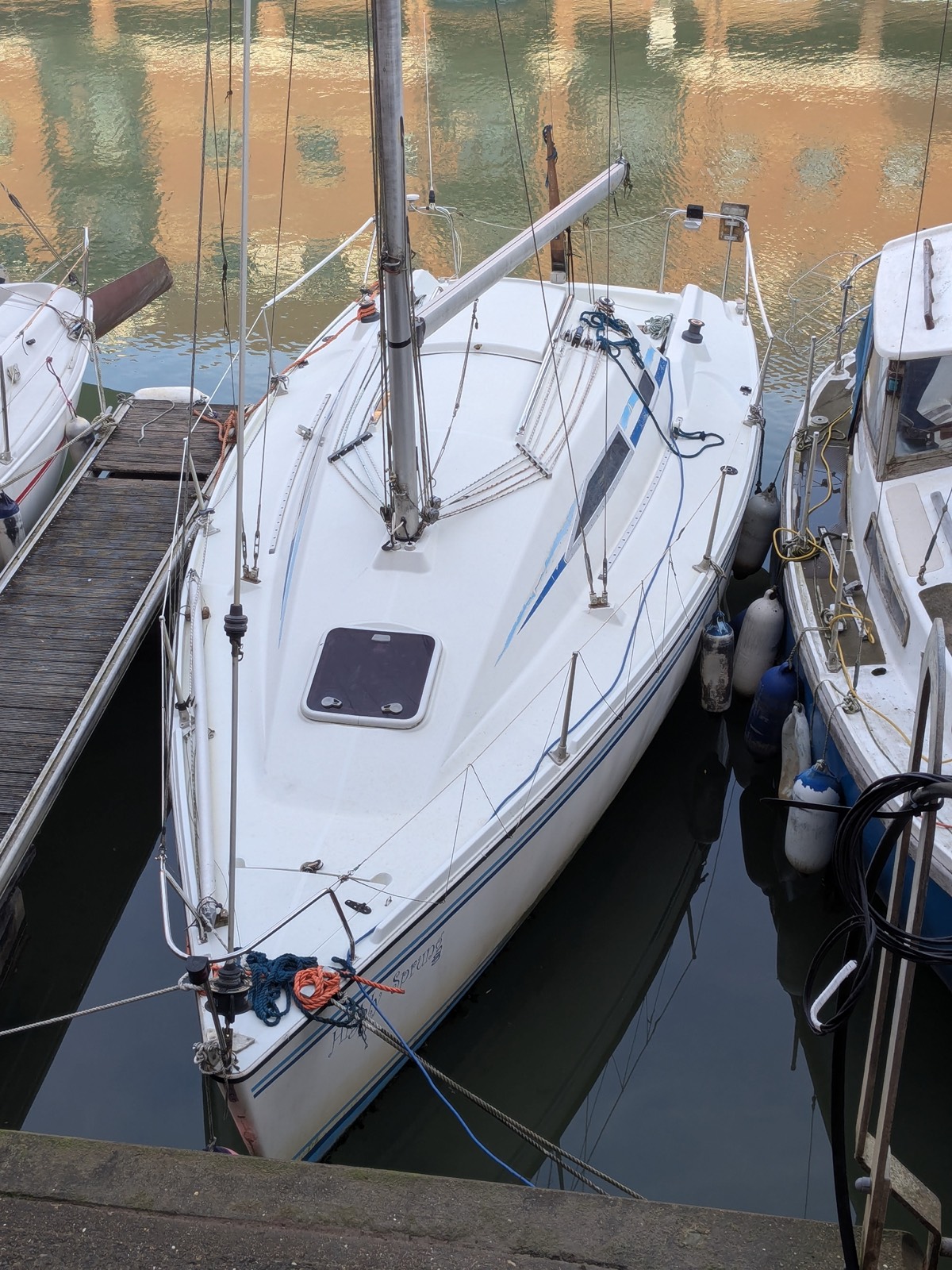 Highly Sprung, a racer-cruiser, moored in a marina